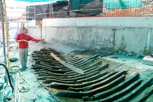 Sprayed water helps preserve the fragile remains of the Roman boat.